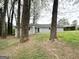 View of the backyard featuring a patio, grassy area, and the home's gray siding at 2942 Elkhorn Ct, Decatur, GA 30034