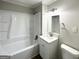 Updated bathroom featuring a sleek vanity, modern fixtures, and a combined tub/shower at 2942 Elkhorn Ct, Decatur, GA 30034