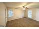 Comfortable bedroom featuring plush carpet, a ceiling fan, and natural light from windows at 2942 Elkhorn Ct, Decatur, GA 30034
