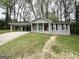 Charming single-story home with covered carport and inviting front porch amidst mature trees at 2942 Elkhorn Ct, Decatur, GA 30034