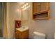 Simple bathroom features single vanity and toilet with natural light at 3011 Broughton Rd, Newborn, GA 30056