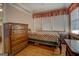 Bedroom with wood floor, natural light, and antique wood dresser at 3011 Broughton Rd, Newborn, GA 30056