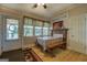Dining room features wood floor, long bench, and large windows offering natural light at 3011 Broughton Rd, Newborn, GA 30056