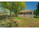 Charming home with a wide porch and stately trees in an expansive green yard at 3011 Broughton Rd, Newborn, GA 30056