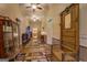 Charming hallway featuring hardwood floors, vintage decor, and a rustic wooden coat rack at 3011 Broughton Rd, Newborn, GA 30056