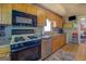 Cozy kitchen with wood cabinets, stainless steel appliances and wood floor at 3011 Broughton Rd, Newborn, GA 30056
