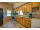 Rustic kitchen features wood cabinets, granite countertops and stainless appliances at 3011 Broughton Rd, Newborn, GA 30056