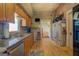 Well-lit kitchen boasts wood cabinets, wood floor and granite countertops at 3011 Broughton Rd, Newborn, GA 30056