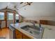 Cozy kitchen with tiled counters and wood floors, flooded with natural light and open to the rest of the room at 3011 Broughton Rd, Newborn, GA 30056