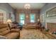 Warm living room with comfortable seating, fireplace, and natural light from two windows at 3011 Broughton Rd, Newborn, GA 30056