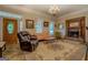 Spacious living room with fireplace, chandelier and ornate rug at 3011 Broughton Rd, Newborn, GA 30056