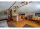 Attic living space with a partial kitchen, a bed, and cozy seating at 3011 Broughton Rd, Newborn, GA 30056