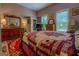 Comfortable bedroom with a view to the bathroom, featuring vintage furnishings and a colorful decorative rug at 3011 Broughton Rd, Newborn, GA 30056