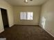 Cozy bedroom featuring a window, plush carpet, and a closet at 7560 Taylor Rd # 5, Riverdale, GA 30274