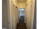 Bright hallway featuring white-washed storage, clean white doors, and hardwood floors leading into the home at 7560 Taylor Rd # 5, Riverdale, GA 30274