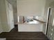 Bright eat-in kitchen featuring updated countertops, white appliances, and luxury vinyl plank flooring at 7560 Taylor Rd # 5, Riverdale, GA 30274