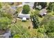 Aerial view of property showcasing mature trees, green lawns, and a charming home with a fenced yard at 2572 Creston Way, Morrow, GA 30260