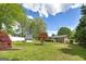 Wide backyard featuring mature trees, a patio, a shed and a fenced perimeter at 2572 Creston Way, Morrow, GA 30260