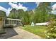A spacious backyard features a patio, a shed, and lush landscaping at 2572 Creston Way, Morrow, GA 30260
