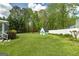 This backyard has a green lawn, a storage shed, and mature trees at 2572 Creston Way, Morrow, GA 30260
