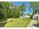 A large, lush backyard features a shed, a patio and mature trees at 2572 Creston Way, Morrow, GA 30260
