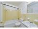 Bathroom featuring classic yellow tile, a tub and shower combo, and a vanity at 2572 Creston Way, Morrow, GA 30260