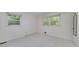 Bedroom featuring natural light, two windows overlooking the outdoor landscape and neutral carpet at 2572 Creston Way, Morrow, GA 30260