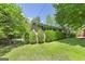 A home surrounded by lush trees, vibrant green shrubbery, and well-maintained lawn at 2572 Creston Way, Morrow, GA 30260