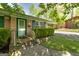 The brick home has a covered carport and manicured landscaping at 2572 Creston Way, Morrow, GA 30260