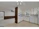 Eat-in kitchen that flows into a living area, with white cabinets and appliances at 2572 Creston Way, Morrow, GA 30260