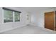 Bright living room featuring a large window, neutral carpet, and a classic door at 2572 Creston Way, Morrow, GA 30260