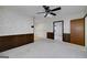 Open living area with wood-paneled walls and access to other living spaces in the home at 2572 Creston Way, Morrow, GA 30260