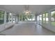 Bright sunroom featuring many windows, ceiling fan, and tile floor overlooking backyard at 2572 Creston Way, Morrow, GA 30260
