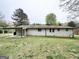 Backyard view of white brick home with covered patio and spacious grassy area at 6026 S Bear Dr, Douglasville, GA 30135