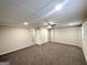Finished basement features neutral carpeting, recessed lighting, and a ceiling fan at 6026 S Bear Dr, Douglasville, GA 30135