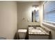 Bright bathroom features granite vanity, modern lighting, and a window with natural light at 6026 S Bear Dr, Douglasville, GA 30135