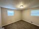 Sunny bedroom featuring neutral walls, carpet flooring and natural lighting from two windows at 6026 S Bear Dr, Douglasville, GA 30135
