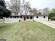 Charming ranch-style home with a freshly painted exterior and meticulously maintained lawn at 6026 S Bear Dr, Douglasville, GA 30135