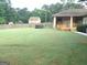 Spacious backyard with fenced yard, gazebo, and additional structure for versatile outdoor enjoyment at 6279 Giles Rd, Lithonia, GA 30058