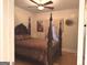 Spacious bedroom features a four-poster bed, ceiling fan, and light colored walls at 6279 Giles Rd, Lithonia, GA 30058