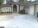 Circular driveway leading to a well-maintained home with mature trees at 6279 Giles Rd, Lithonia, GA 30058