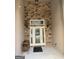 Inviting front door with stone surround, decorative glass, and elegant lighting at 6279 Giles Rd, Lithonia, GA 30058