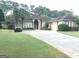 Beautiful home with a well-manicured lawn, circular driveway, and palm trees at 6279 Giles Rd, Lithonia, GA 30058