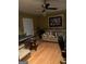 Living room featuring a comfortable leather sofa set, ceiling fan, and hardwood floor at 6279 Giles Rd, Lithonia, GA 30058