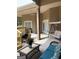 Covered patio with ceiling fan offers a comfortable space for outdoor dining and lounging with wicker furniture at 6279 Giles Rd, Lithonia, GA 30058