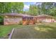Landscaped backyard featuring a deck, screened porch, and well-maintained lawn at 205 Olde Oak Dr, Jonesboro, GA 30238