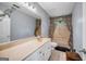 The bathroom features a large mirror, extended vanity and a shower with patterned curtains at 205 Olde Oak Dr, Jonesboro, GA 30238