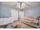 A cozy bedroom featuring a double closet, dresser and a comfortable bed with pink accents at 205 Olde Oak Dr, Jonesboro, GA 30238