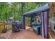 Cozy outdoor deck with seating, grill, and a covered gazebo for relaxation and entertainment at 205 Olde Oak Dr, Jonesboro, GA 30238