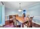 Formal dining room features hardwood floors, decorative lighting, and elegant furniture set at 205 Olde Oak Dr, Jonesboro, GA 30238